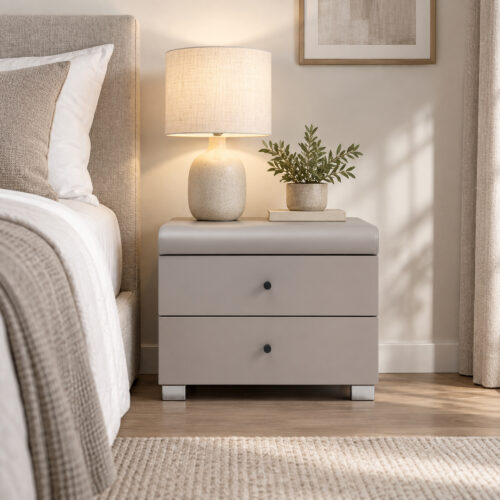 Cove Grey Two-Drawer Bedside Table — front view beside a bed