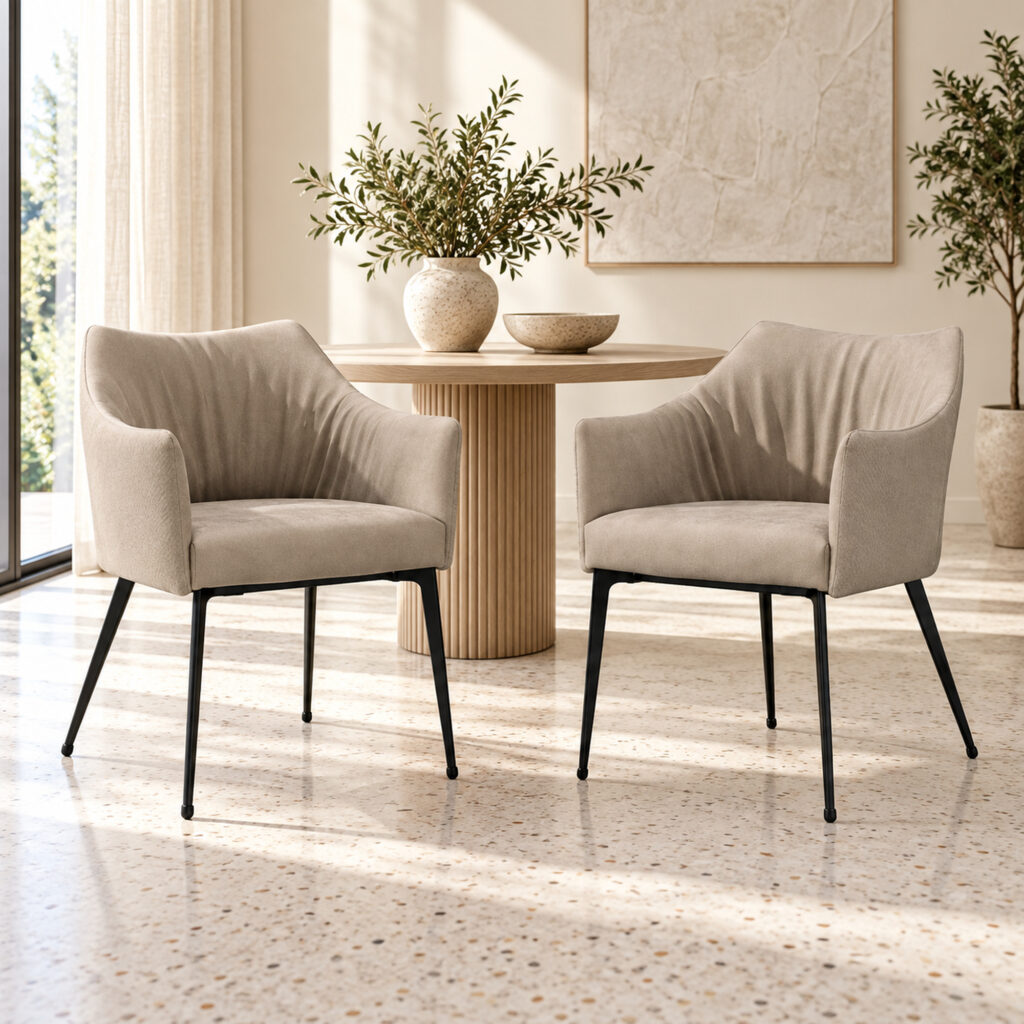Harrow Dining Chair Set — two matching taupe chairs, side-front view beside an apartment window on terrazzo flooring. Other furnishings are staging only.