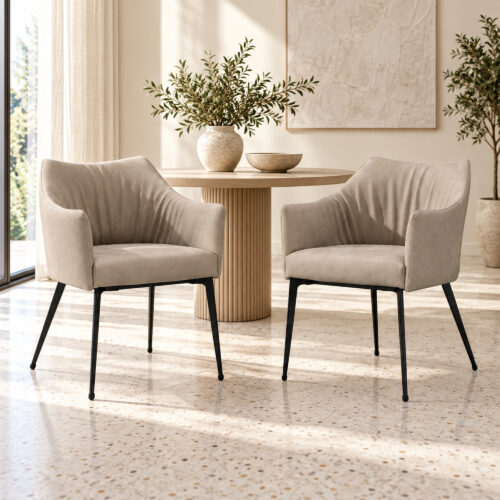 Harrow Dining Chair Set — two matching taupe chairs, side-front view beside an apartment window on terrazzo flooring. Other furnishings are staging only.