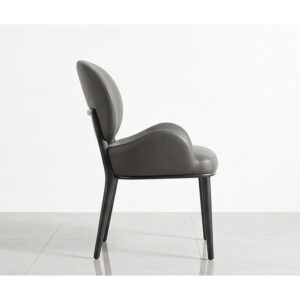 Supplier side view of one Huxley chair showing curved low arms and slim black legs; listing includes two chairs.