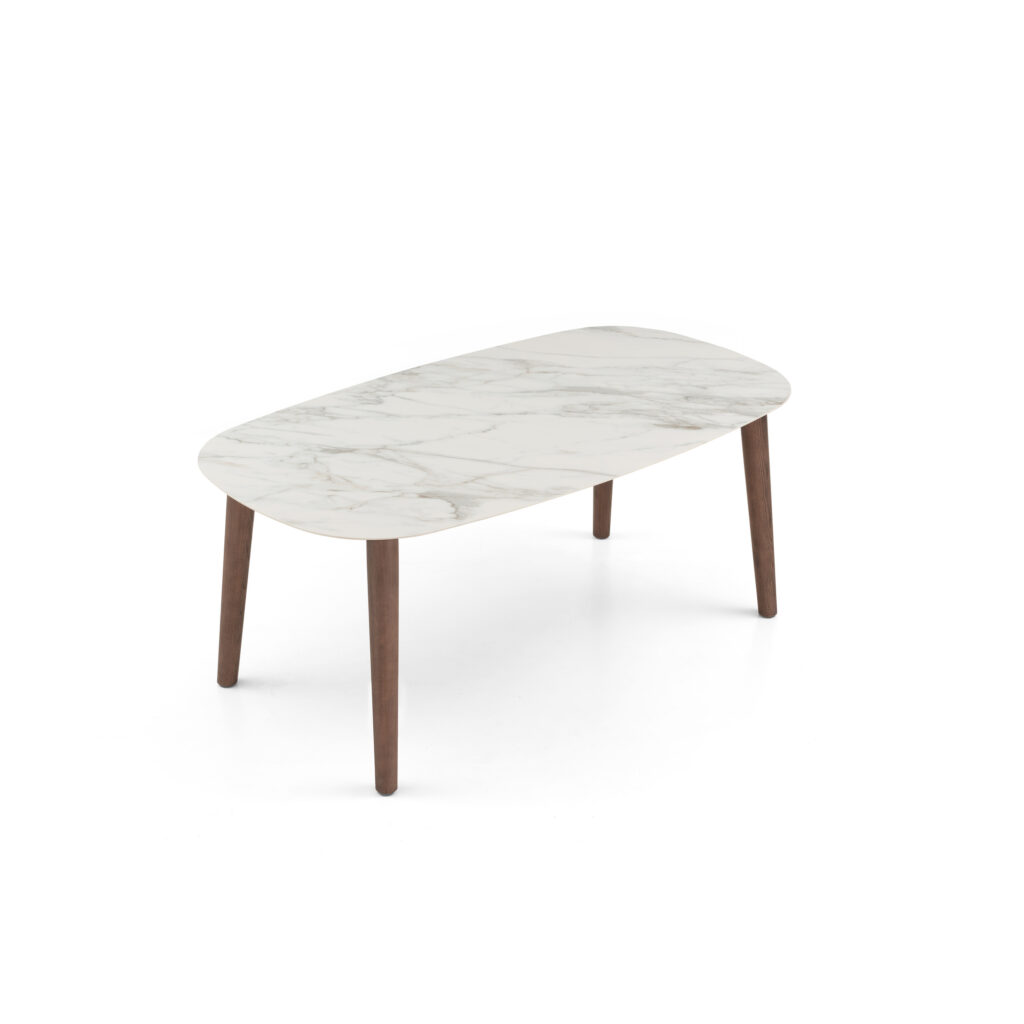 Supplier elevated three-quarter view of the white sintered stone oval dining table with wood frame and four legs.