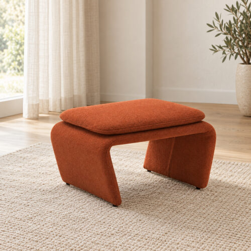 Rylan Camel Fabric Footstool with Curved Upholstered Supports — three-quarter view in a light lounge