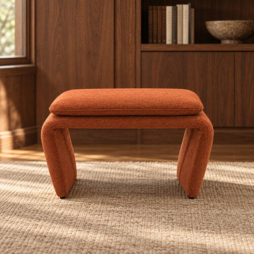 Rylan Camel Fabric Footstool with Curved Upholstered Supports — front view in a walnut room