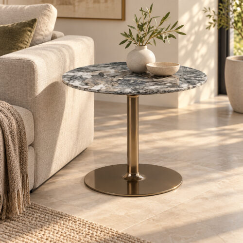 Grey Swirl Sintered Stone Pedestal Side Table — side table beside an armchair with a vase and bowl